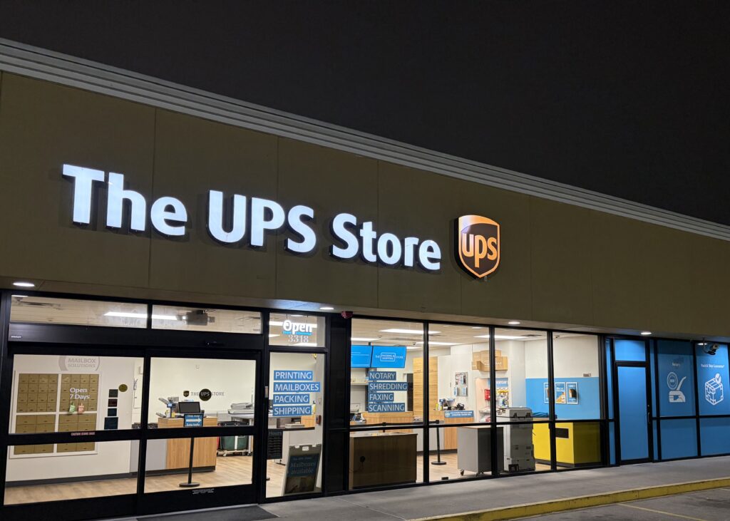The UPS Store #4747 located in Nederland, TX shown at night.